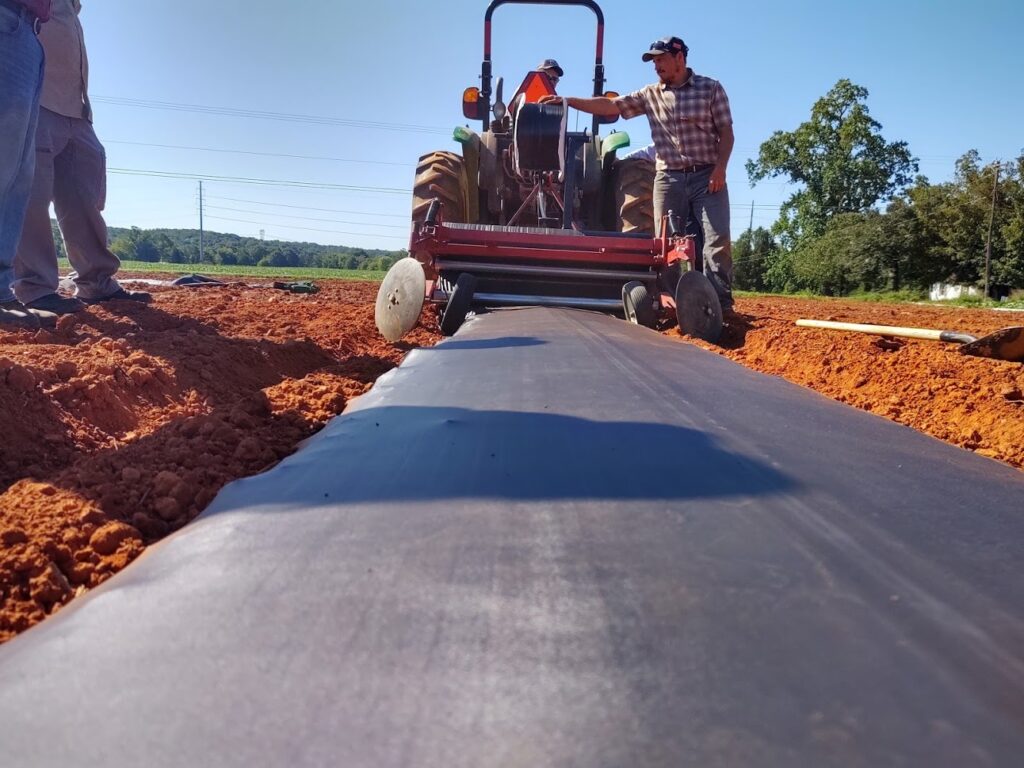 laying plastic mulch with a mulch layer implement