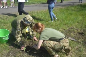 Two Ukraine soldiers plant a tree